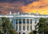 DOJ Targets TV ‘Boycott’ at White House The White House with vibrant sunset sky.