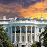 DOJ Targets TV ‘Boycott’ at White House The White House with vibrant sunset sky.