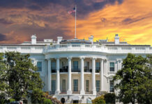 The White House with vibrant sunset sky.
